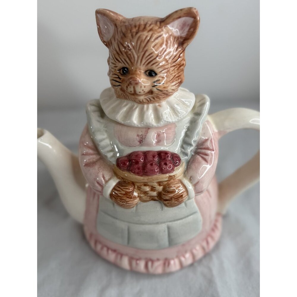 Vintage Ceramic Cat-Shaped Teapot With Pink Dress & Ruffled Collar Holding Baske